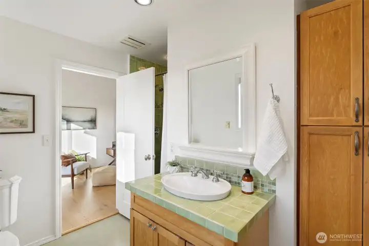 The shade of seagrass gives this upstairs bathroom a beautiful glow, with a walk-in shower and linen cupboard, its shared by both upstairs bedrooms.