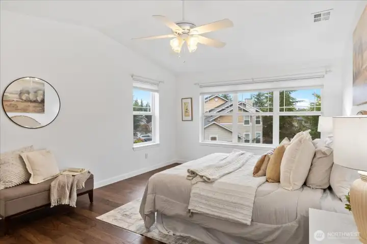 Primary bedroom with vaulted ceiling