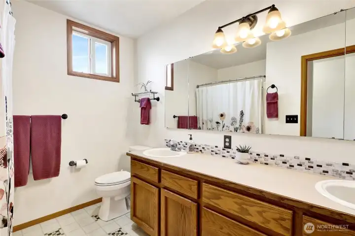 This full bath serves the upper level.