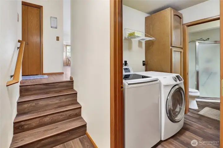 Steps from the foyer access the lower level, where a spacious laundry room serves the home.