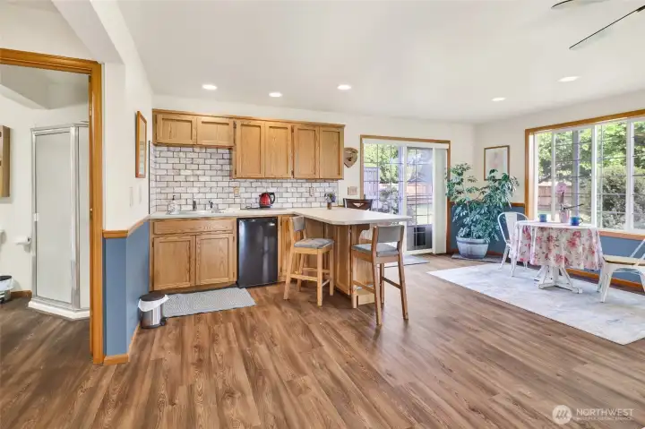 The kitchenette features a sink & mini fridge as well as bar seating.