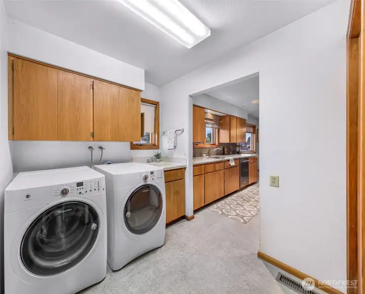 Laundry Room with washer and dryer that stay with the home and a utility sink