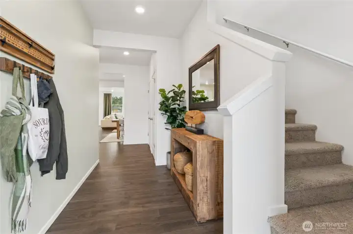 Large foyer perfect for a bench or coat rack. Actual home is under construction and finishes, materials, and colors will vary. See site agent for details.