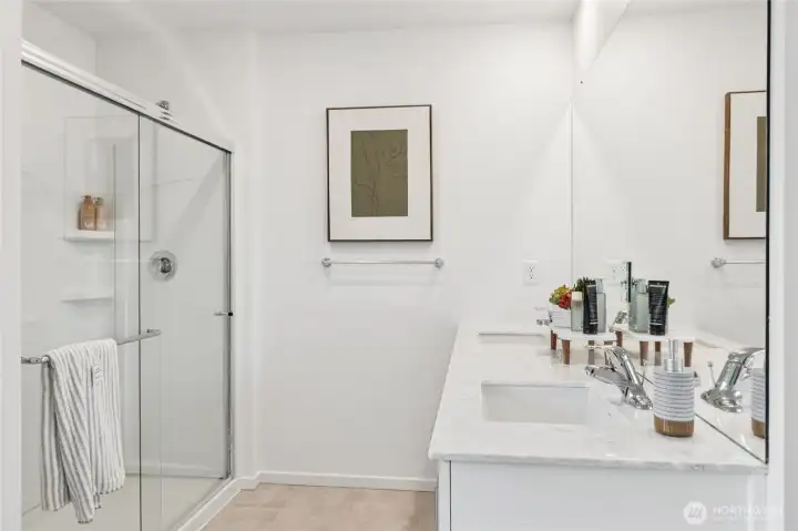 Double vanity in the primary bathroom. Actual home is under construction and finishes, colors, and materials may vary. See site agent for details.