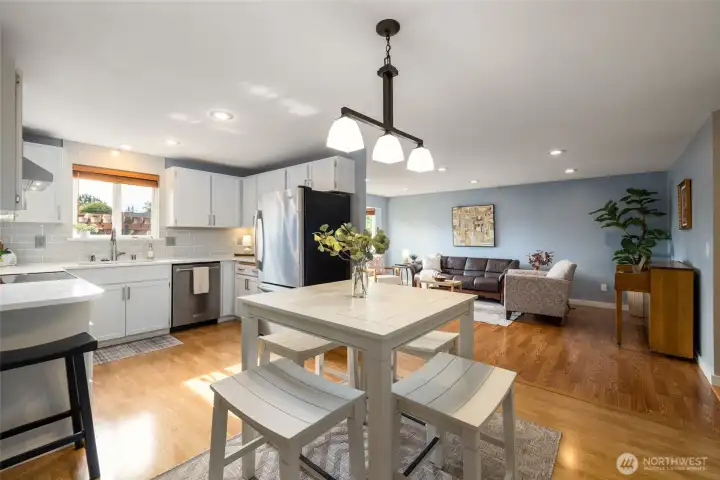 A view from the dining area into the kitchen and living room.