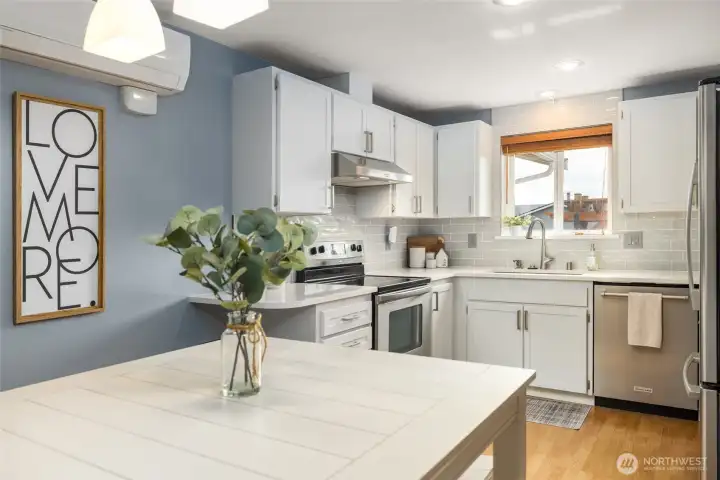 Lovely, updated kitchen features quartz counters, stainless appliances, subway tile backsplash.  Easy care laminate flooring.