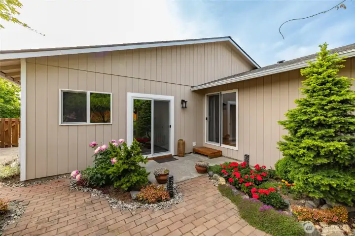 Two sliders give access to the back yard. One from the family room (left) and one from the primary suite (right).
