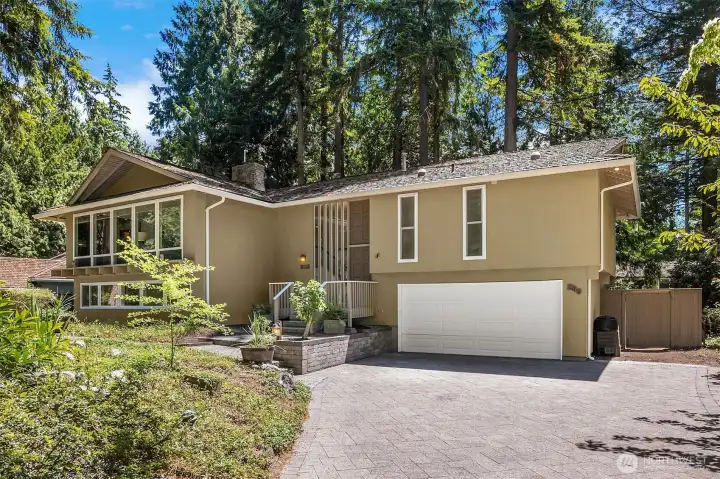 Attractive curb appeal framed by mature landscaping.