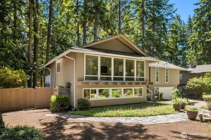 A picturesque setting surrounded by mature trees.