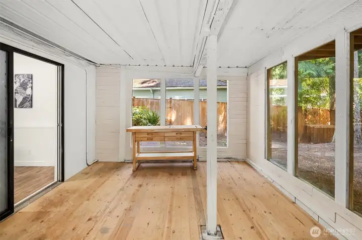 Charming enclosed sunroom overlooking the backyard.