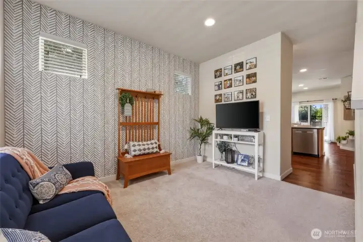 The accent wall gives a delightful style and fresh feel!  Kitchen is seen beyond...