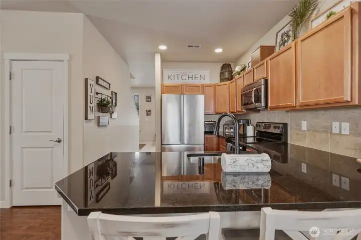 Pantry provides bonus storage beyond the numerous cabinets; granite slab counters provide that smooth, finished feel--classy and easy to clean!