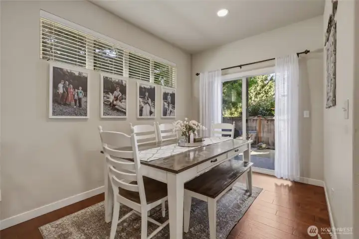 The dining space off the kitchen is light and bright and features the hand-scraped style of flooring seen on the main floor.  Slider leads to the peaceful patio out back!