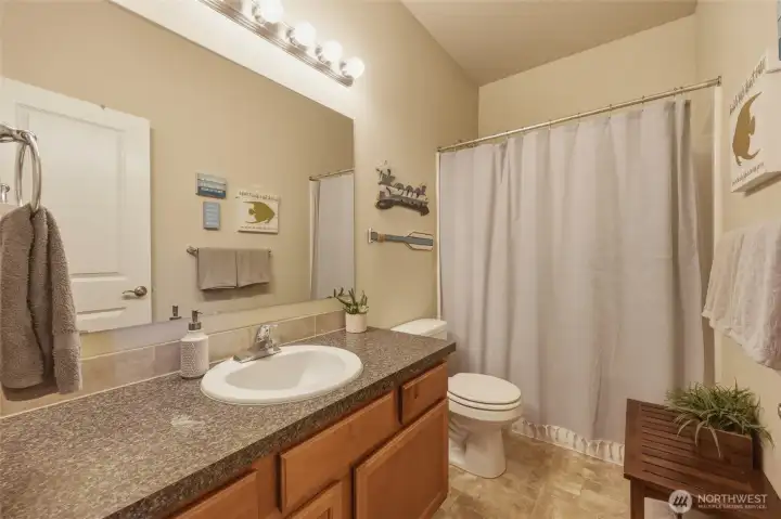 Full bath off main hallway upstairs, next to bedrooms.