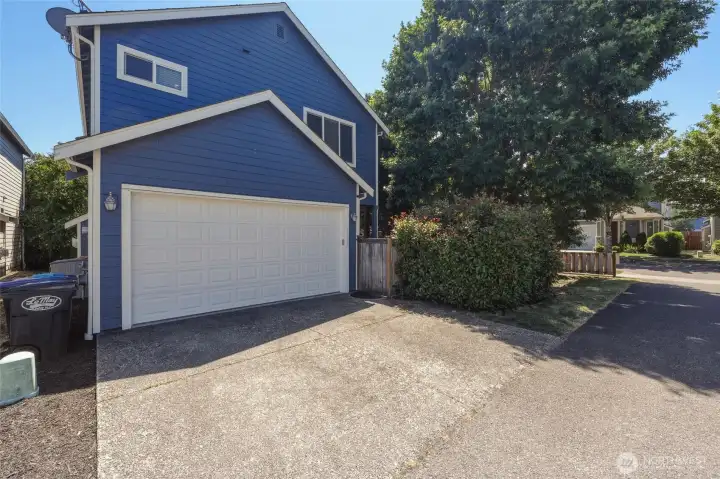 This alley view shows the quick garage accessibility and gate to back patio.