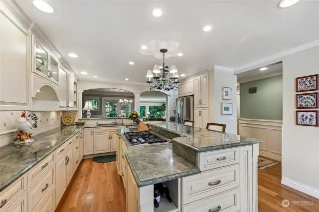Exquisitely remodeled kitchen with creme brulee cabinets topped with gorgeous green slab granite.