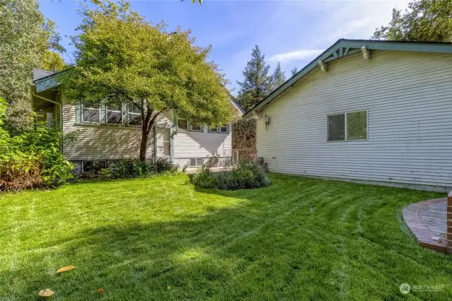 Back yard showing the side of the double car garage