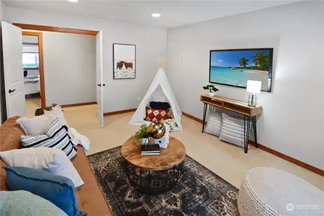 Upstairs den/TV room provides a versatile space for entertainment or relaxation.