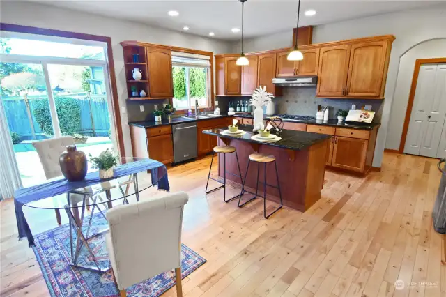 Your chefs kitchen has gorgeous solid wood cabinets. Sliding doors to the large back patio and note the lovely wood trim around the windows and doors. Large pantry, Gas cook top, new dishwasher and refrigerator all included for you.