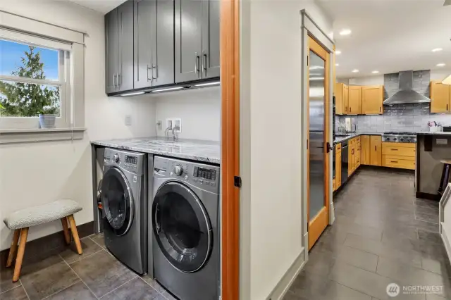 Laundry room has built-in custom cabinets