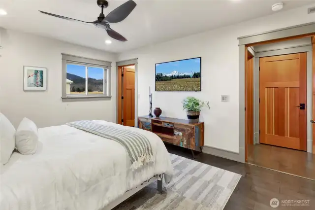 Main floor primary bedroom has a walk-through closet with custom built-ins and a large bathroom