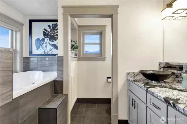 The upstairs primary bath has double-sinks, a jetted soaker tub, and a large shower