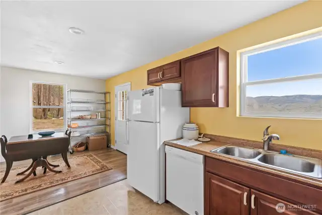 Kitchen with full fridge and dishwasher