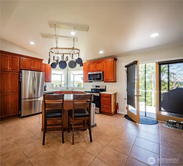 KITCHEN ISLAND AND FRENCH DOOR TO THE MASSIVE DECK