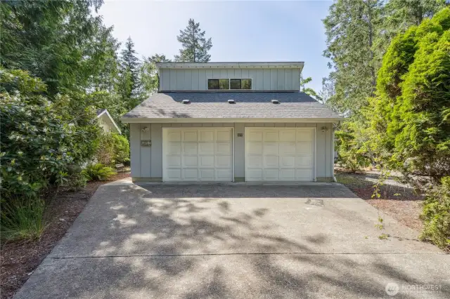 Detached 2 car garage is extra deep, has separate shop space, and a bonus room above.