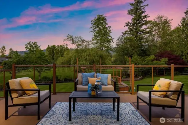 Spacious deck perfect for entertaining, unwinding, and taking in the peaceful natural surroundings.                                  Lower-level rec room with wet bar and cozy fireplace—perfect for entertaining.