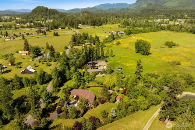 Outbuildings, barn, and greenhouse add space for animals, gardening, equestrian pursuits, or business ideas—imagine a wellness retreat, Airbnb, or wedding venue.
