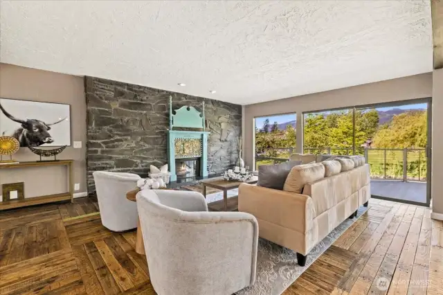 Floor to ceiling stone fireplace. Take in the incredible views from the living room every morning. Oversized glass sliding doors leads to the back deck.