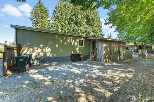 Backside of home with covered enclosed porch