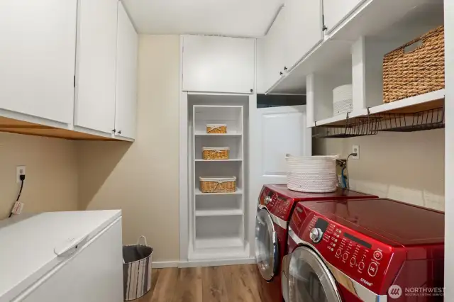 The laundry room has storage upon more storage for epic organization plus a huge bonus chest freezer!