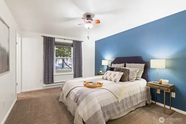 The primary bedroom feels spacious and calm, tucked at the end of the hallway, overlooking the quiet yard opposite the driveway and shop for thoughtful peace and quiet where you want it.