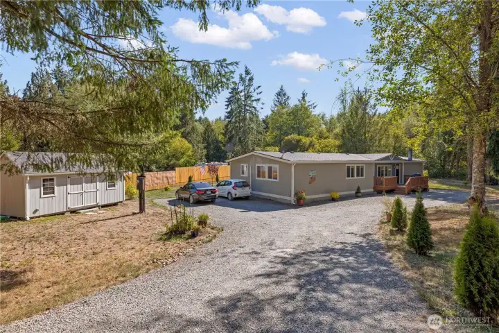 View when entering fully fenced property. With parking and with a storage shed with power for your hobbies.