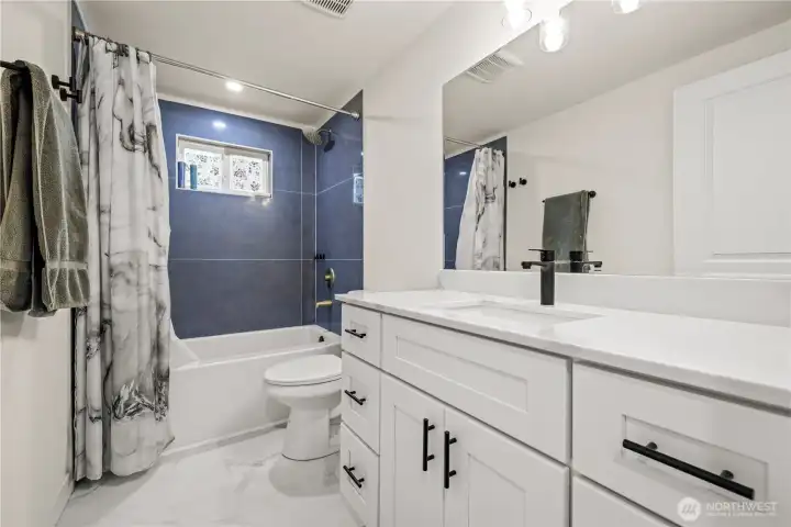 Full Bathroom, with shower, fully updated. Black accent handles and faucet.