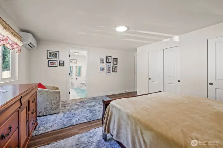 View of primary bedroom with walkway towards your primary bathroom.