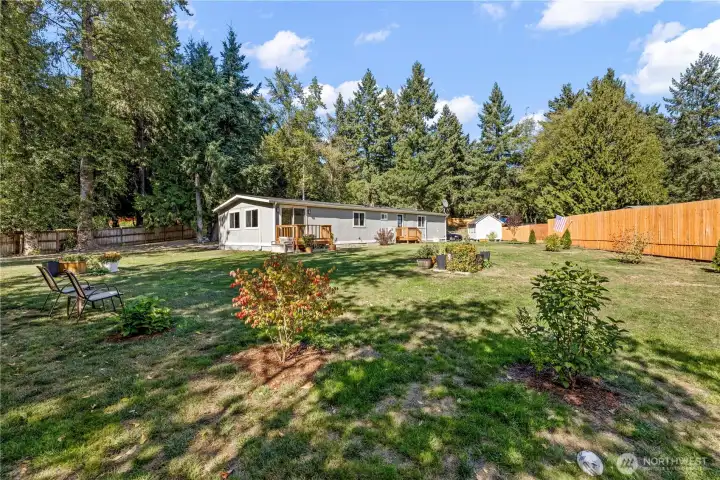 Space for gardening and view from backyard to the back of the home.