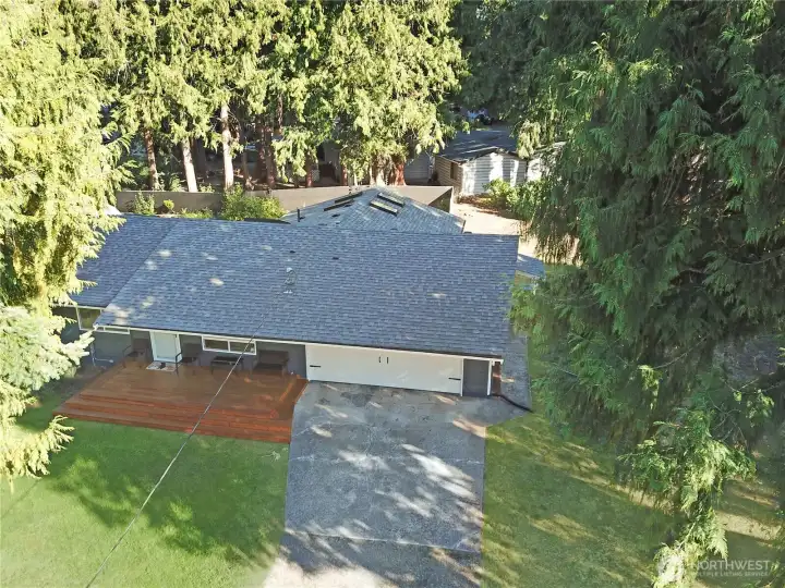 Aerial view of the freshly painted rambler with newer roof (approx. 5 years), front deck, and driveway—great curb appeal near Bonney Lake.