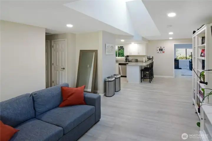 Open main living area with skylight, abundant natural light, and view toward the bedroom wing, kitchen, and dining room—bright Bonney Lake rambler layout.
