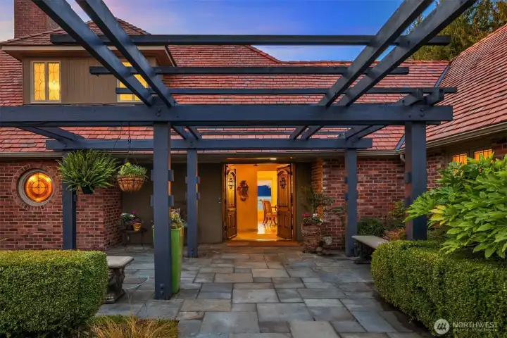 Arrive in style through a breathtaking, custom-designed pergola that serves as a dramatic entryway to this sprawling estate.
