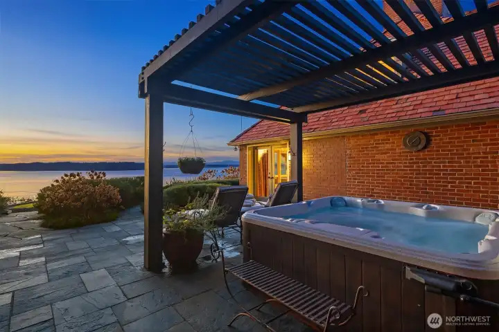 Soak your cares away in the hot tub and retire right to the primary suite. French doors shown here lead to the primary suite.