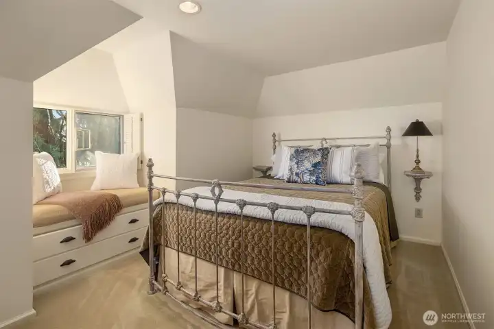 Third upstairs bedroom with window seat and built-ins for additional storage.