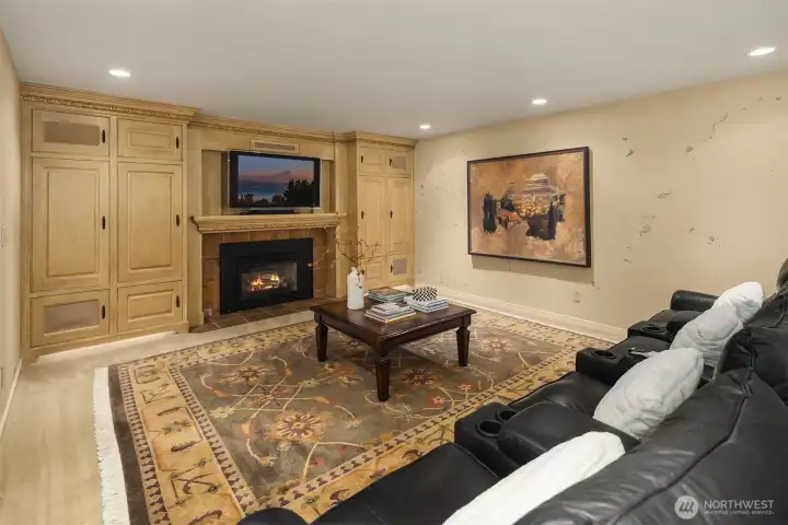 Theater area has a cozy fireplace and built-ins with 5 speaker surround sound with subwoofer.