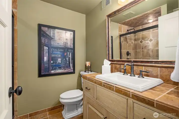 Lower level bath boasts custom tile.