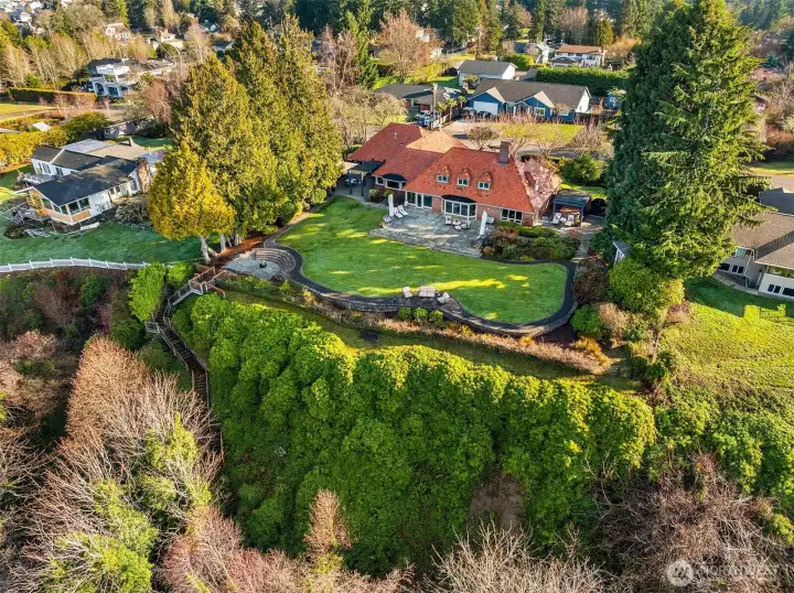 This exclusive home is perched high above the water on a double lot and is professionally landscaped with meticulously manicured lawn and gardens.