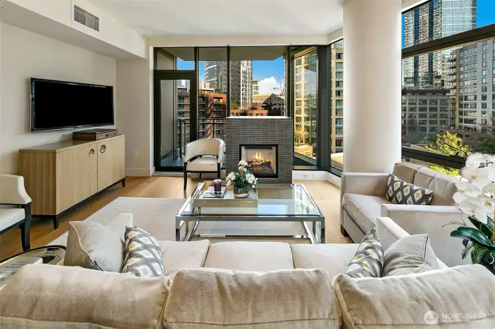Cozy gas fireplace anchors the living room, but does not distract from the floor to ceiling window wall view.