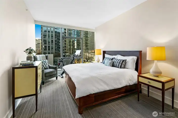 Primary bedroom fit for a king size bed with room to move (or exercise) too.