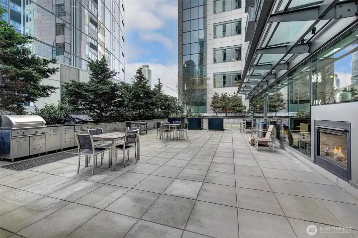 Resident sundeck with multiple barbecue grills, dining tables and chairs for outdoor enjoyment.